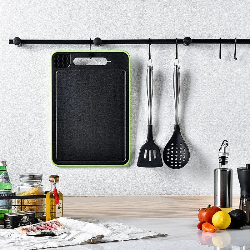 Square grey aluminium double-sided cutting board with defrosting function, built-in knife sharpener, and grinding teeth for garlic prep