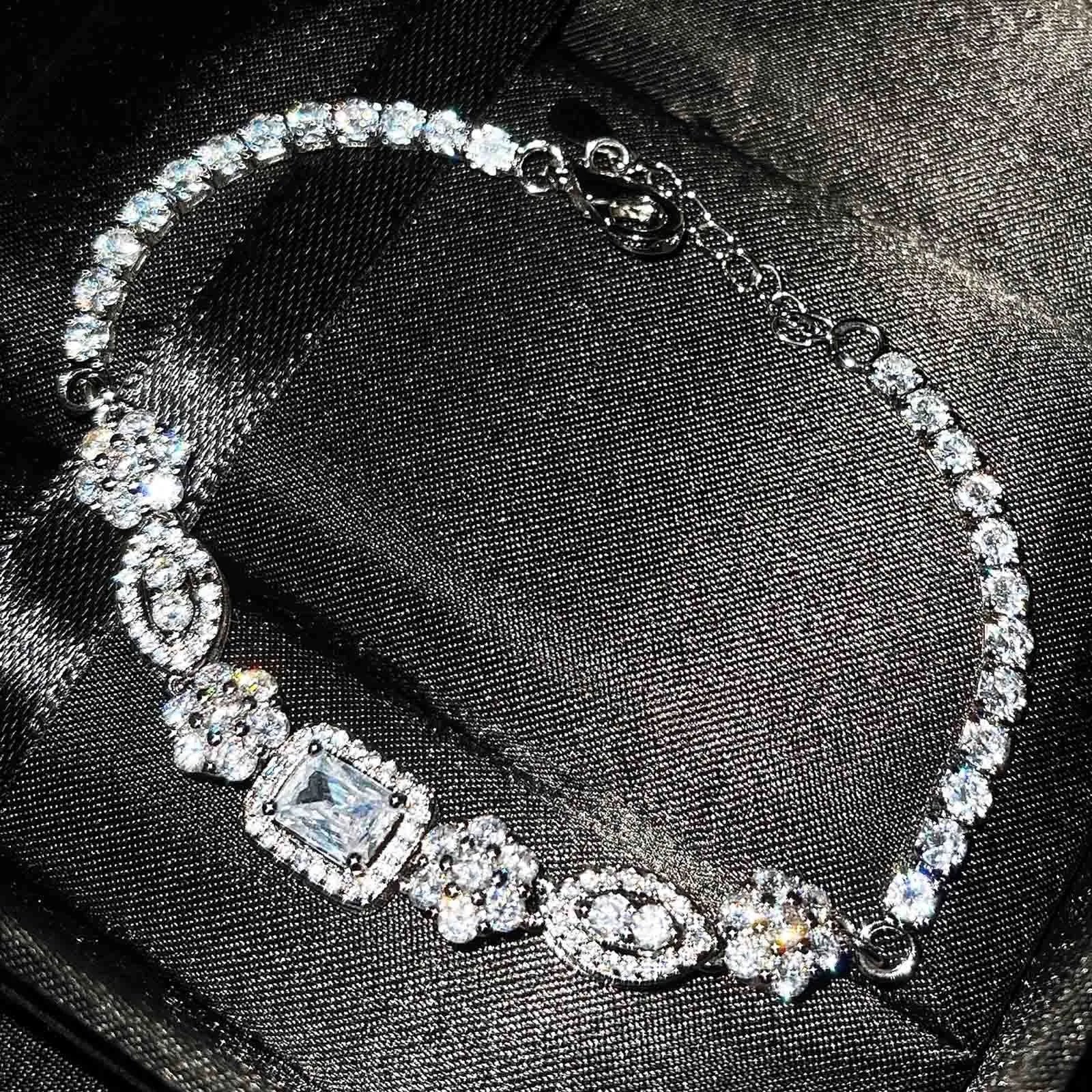 Women's geometric bracelet with zircon stones on silver-toned band showing adjustable and fixed length options