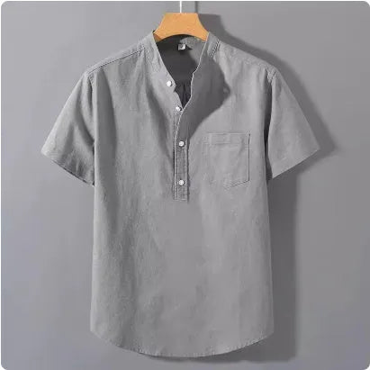 Man wearing a beige slub linen casual shirt with a stand collar and short sleeves, loose fit.