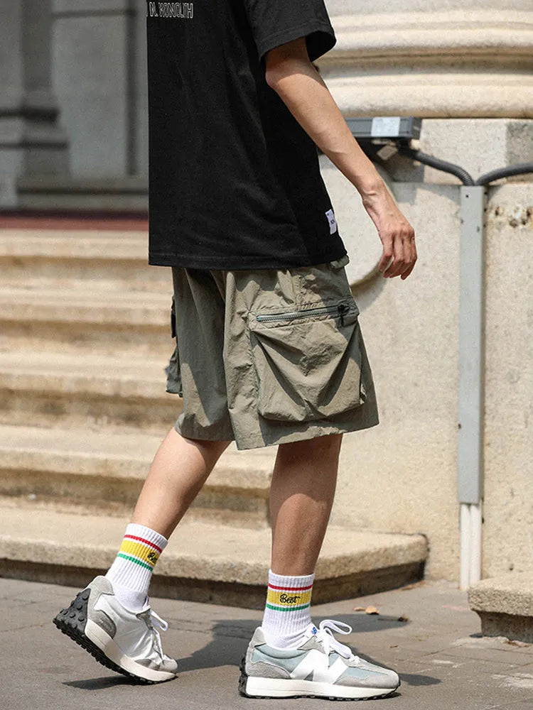 Men's mid-waist cargo shorts in solid green colour made from polyester