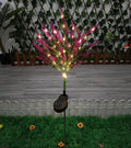 A pink flower-shaped solar LED garden light standing 74 cm tall in an outdoor setting.