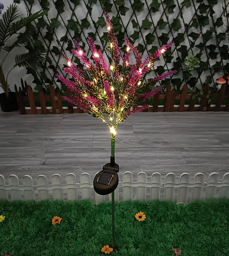 A pink flower-shaped solar LED garden light standing 74 cm tall in an outdoor setting.