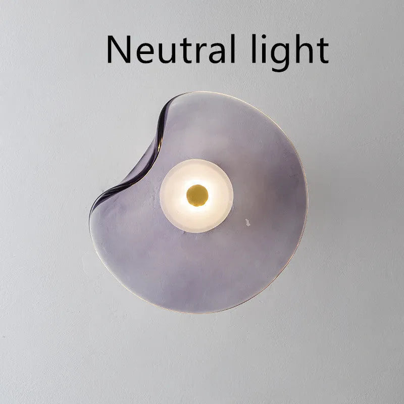 Round glass wall lamp for bedroom bedside in cognac, grey or light colour finishes.