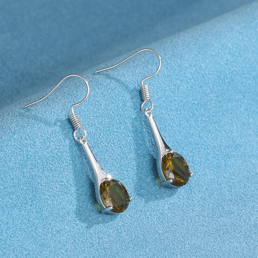 Olive green topaz coloured drop earrings with a water drop shape and minimalist retro design.