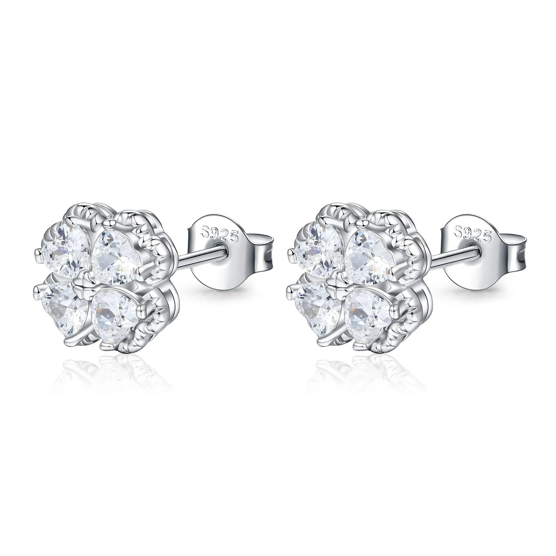 Close-up of women's 925 silver earrings with a four-leaf clover and heart design, inlaid with zircon stones in white gold colour.