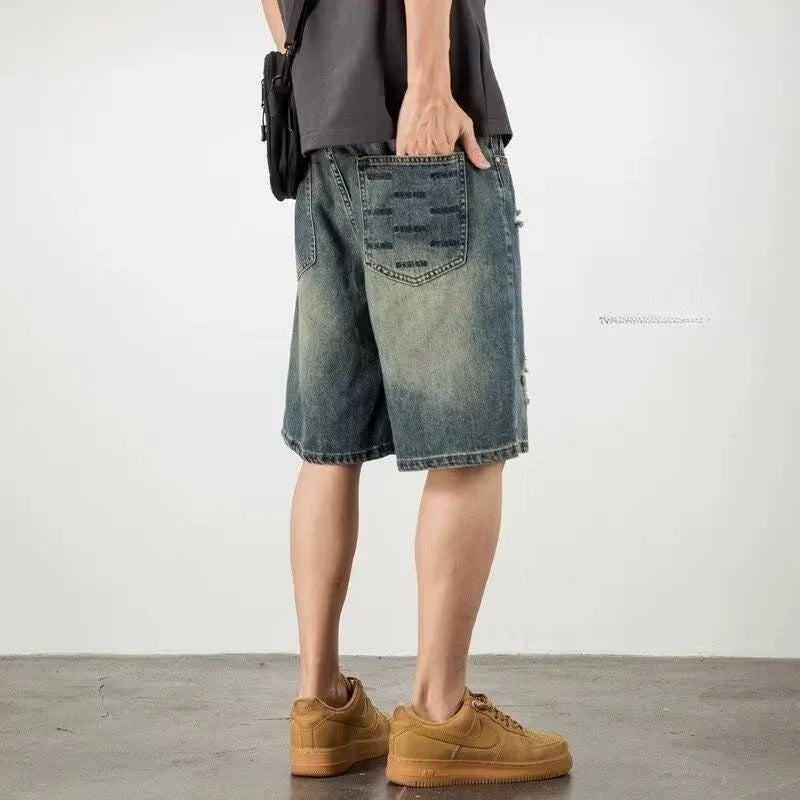 Blue distressed retro denim shorts for men on a white background