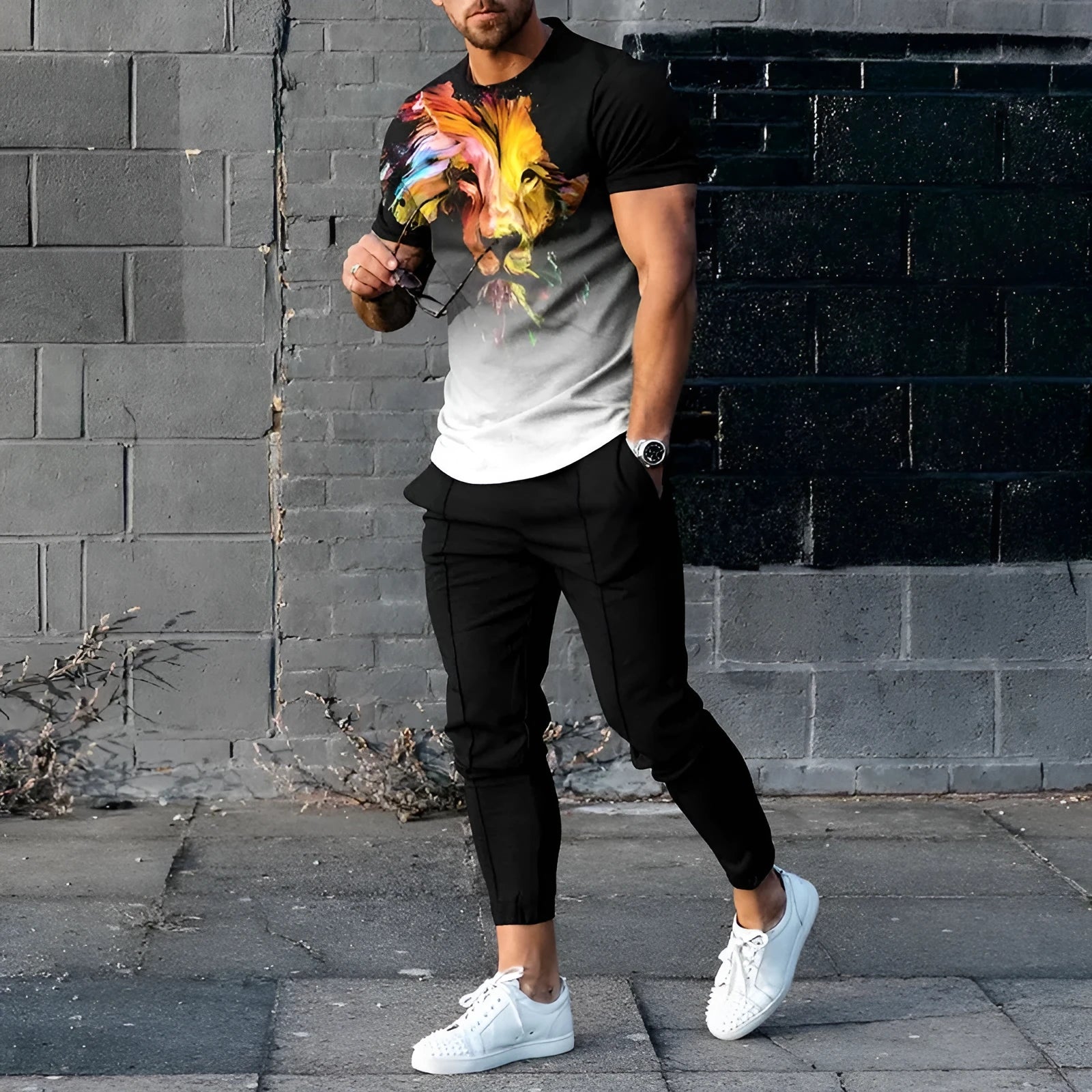 Man wearing a solid-colour short-sleeve top and matching trousers from a polyester sports set.