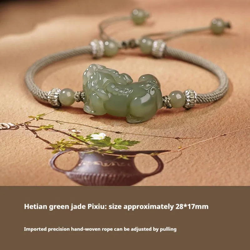 A Hetian jade bracelet with braided black and red rope in a Chinese style design.