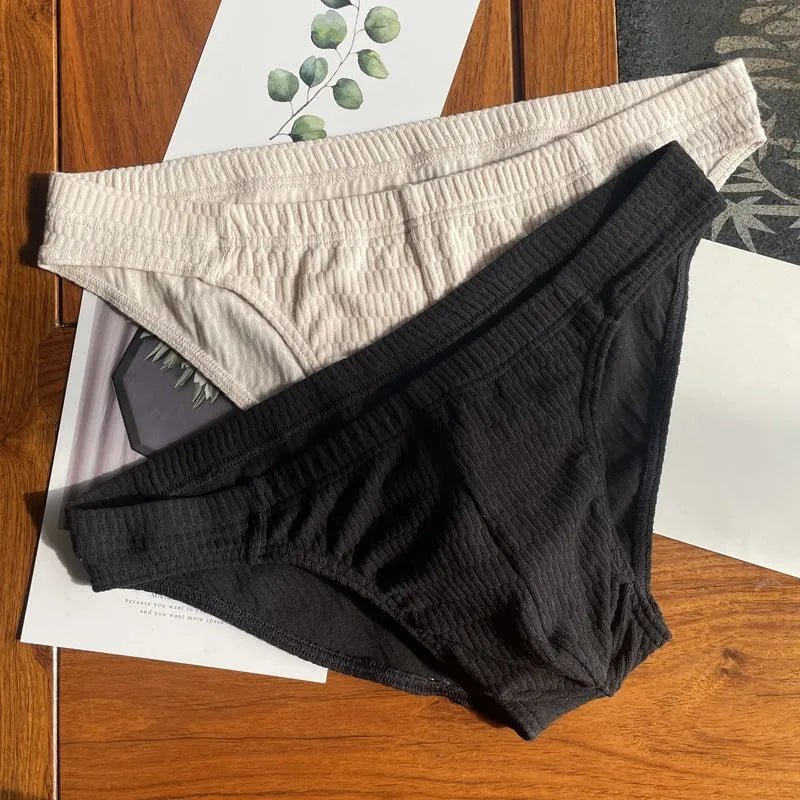 Men's solid colour cotton triangle briefs with a mid-waist waistband on a white background.