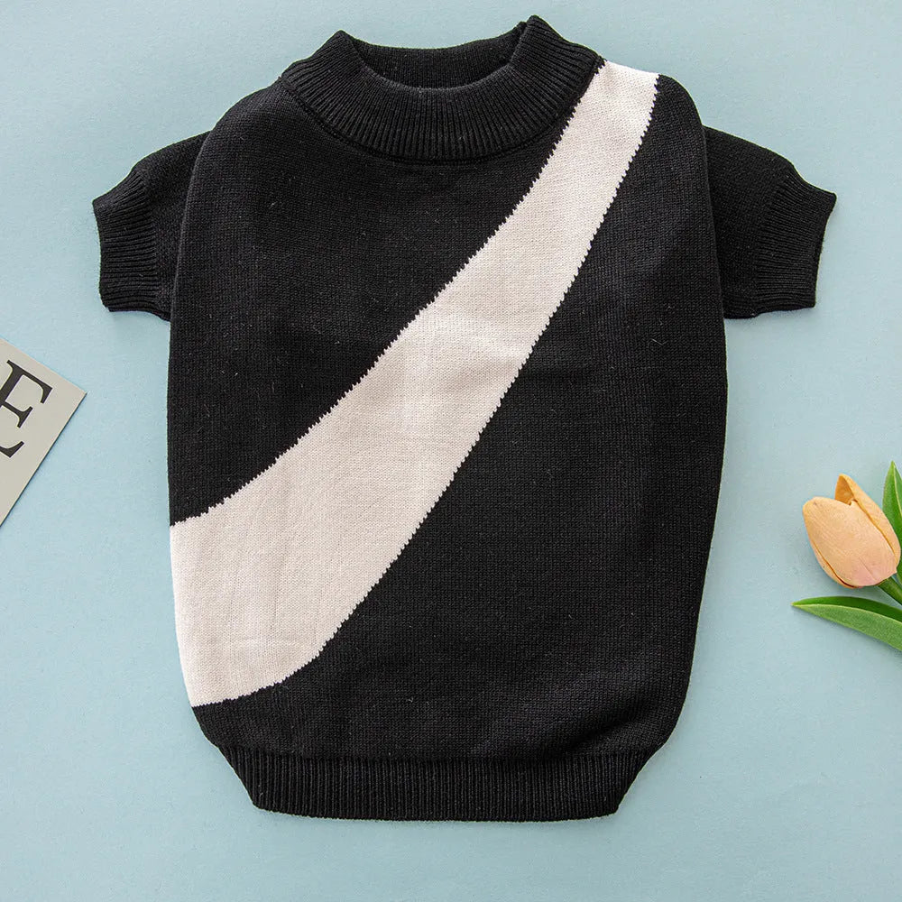 Wool knit dog sweater for corgis and poodles in assorted colours and sizes on a mannequin.