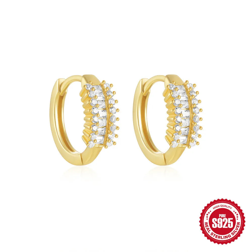 Sterling silver geometric stud earrings with a small round shape and classic diamond detail on a white background.
