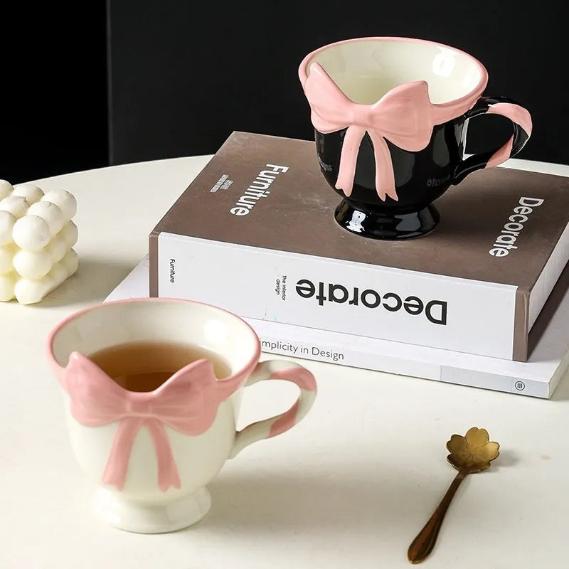Ceramic mug with heart bow design in cute style showing Black Pink and White Powder colour options