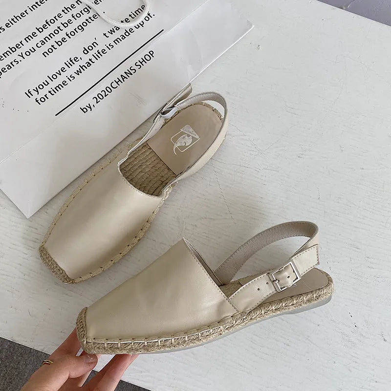 Women's beige retro fisherman flat sandals with canvas upper and animal pattern detail.