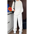 Men's black slim fit two-piece casual suit with long sleeve polo shirt and trousers on a hanger.