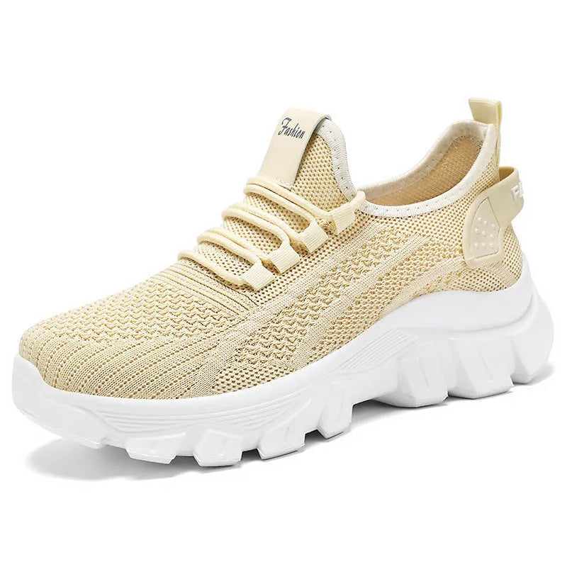 Women's white Flyknit sneaker with thick sole and lace-up front, shown on a neutral background
