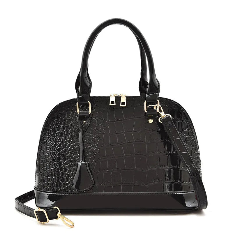 Shiny PU crossbody shoulder bag in shell shape showing black, red, and brown colour options