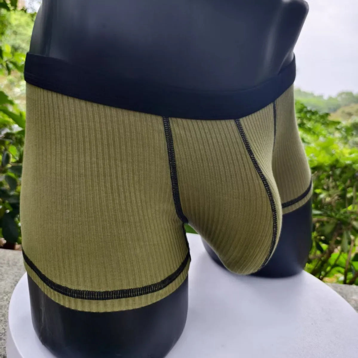 Men's breathable boxers in Army Green solid colour showing thin fabric construction and body shaping design