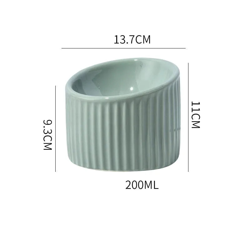 Dark green ceramic elevated cat bowl with tilted, round design for food or water.