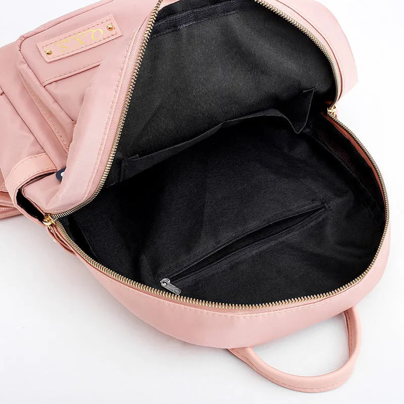 Black and pink casual nylon backpack with double straps, soft handle, and square vertical shape