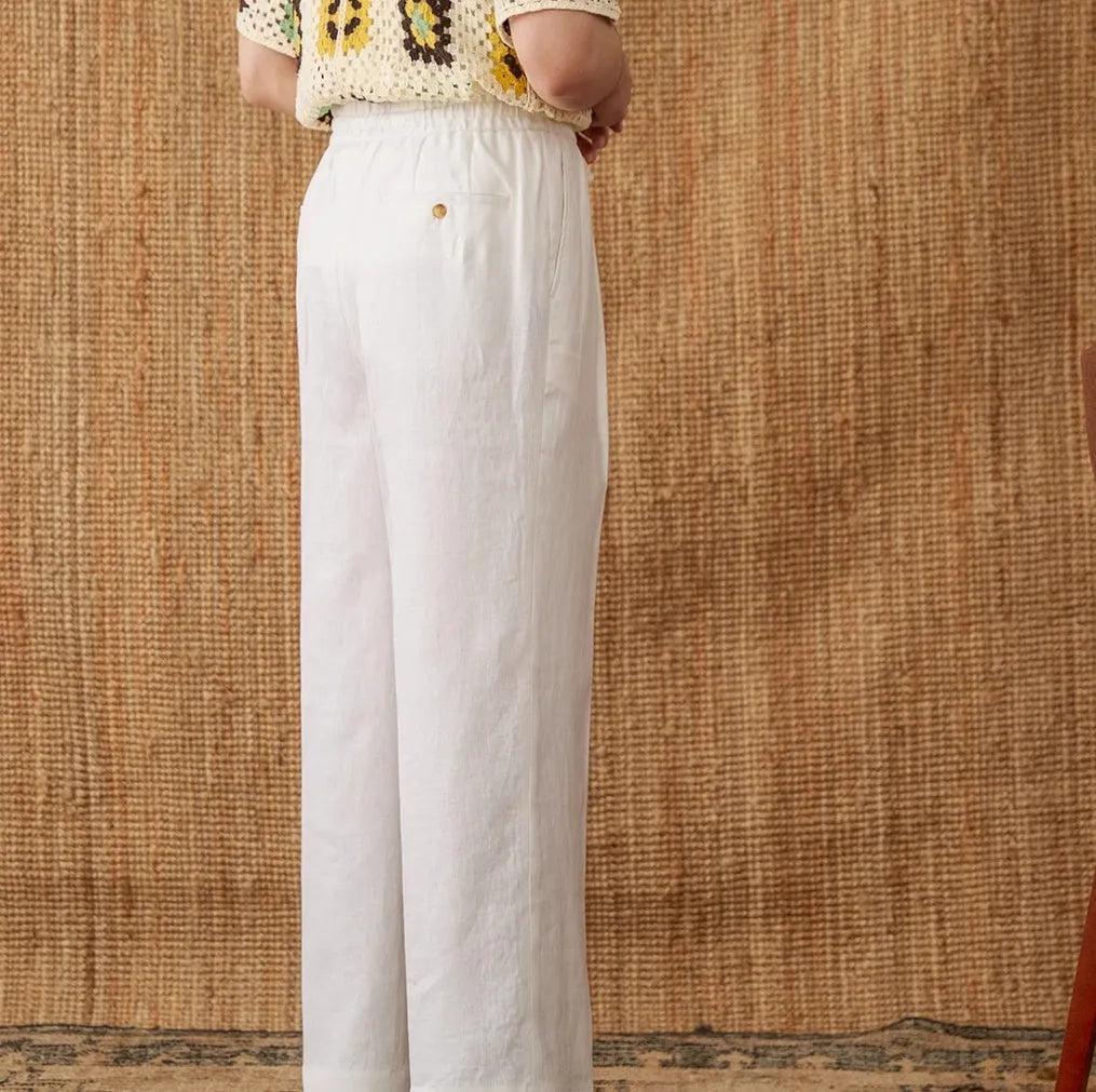 Straight-leg linen trousers with elasticated high waistband in navy blue, white, and greige colours