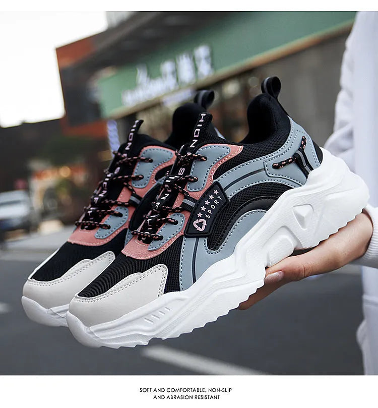 Women's white thick-soled casual sports shoes with mesh upper and buckle detail.