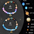 Set of two natural stone beaded bracelets with zodiac charms on a textured background.