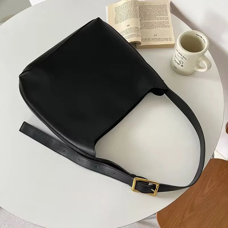 Two women's soft PU shoulder bags with swing threads, one black and one brown, showing structured design.
