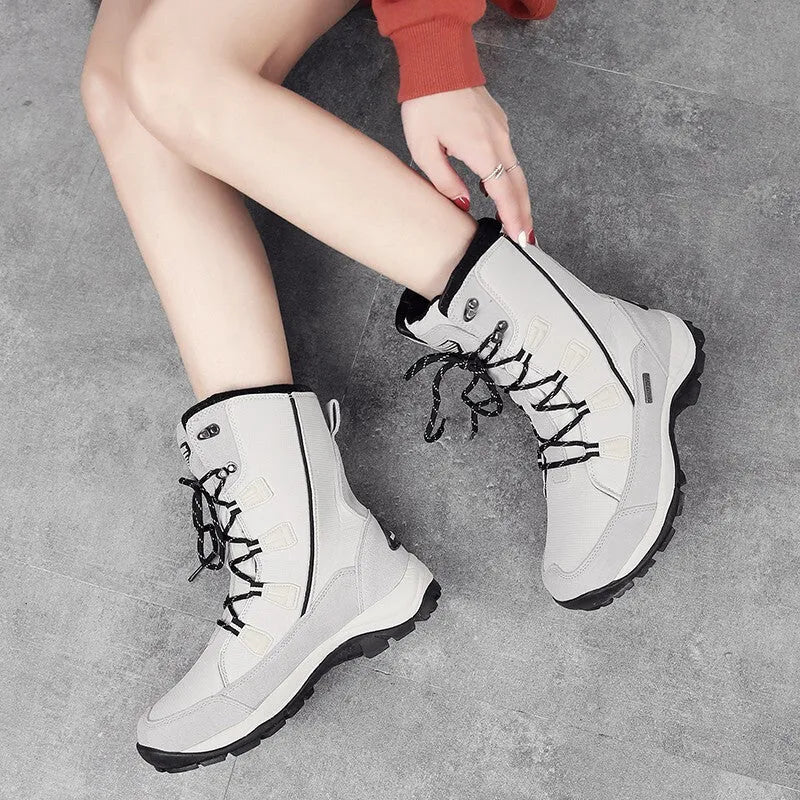 Women's mid-calf genuine leather snow boots in black with a round toe and rubber sole.