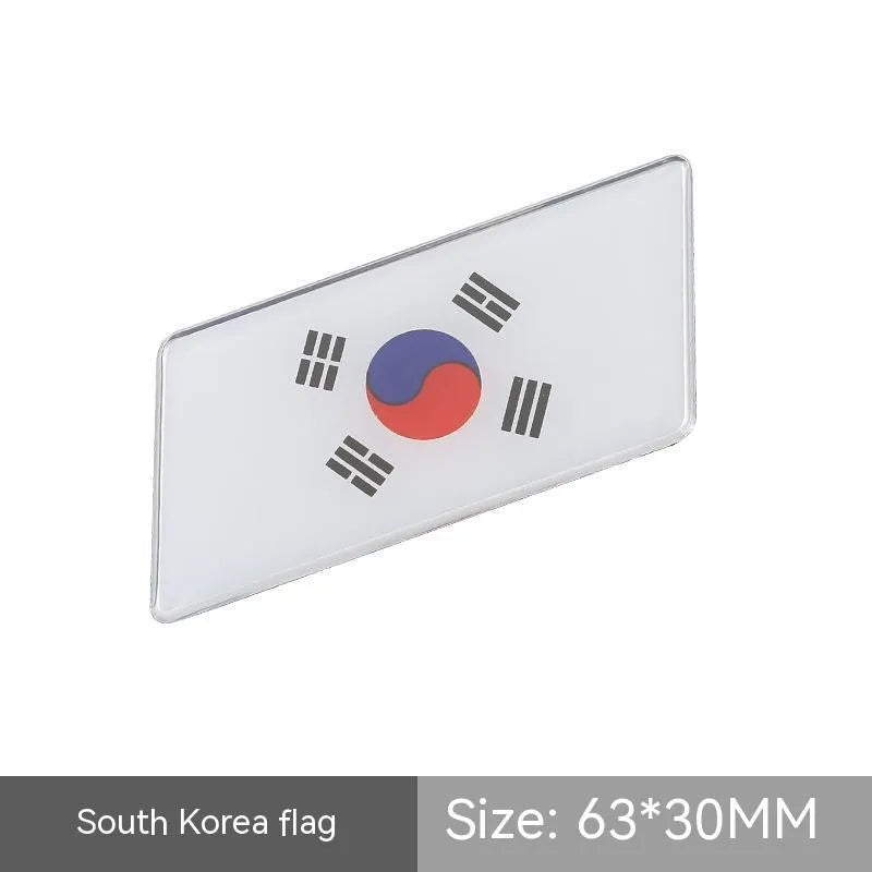 Aluminium metal car sticker with national flag design in a parallelogram shape.