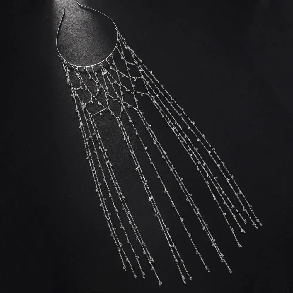Gold and silver rhinestone mesh headband with a decorative tassel accessory.