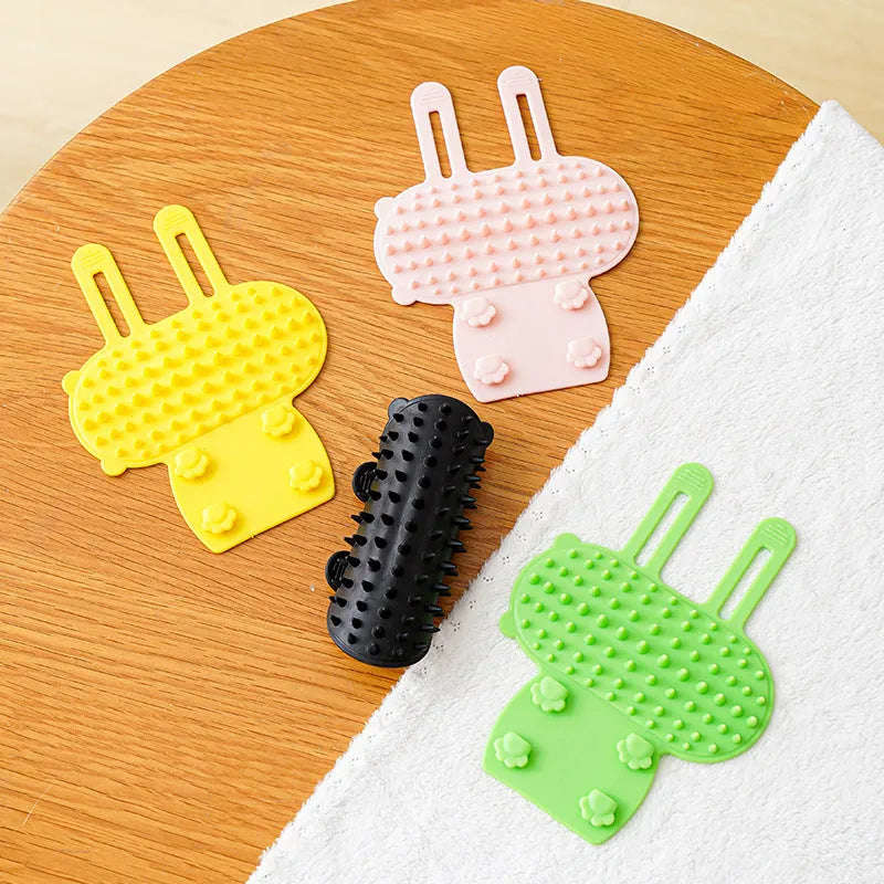 Silicone pet grooming massage comb with rounded teeth and adjustable strap for table leg mounting