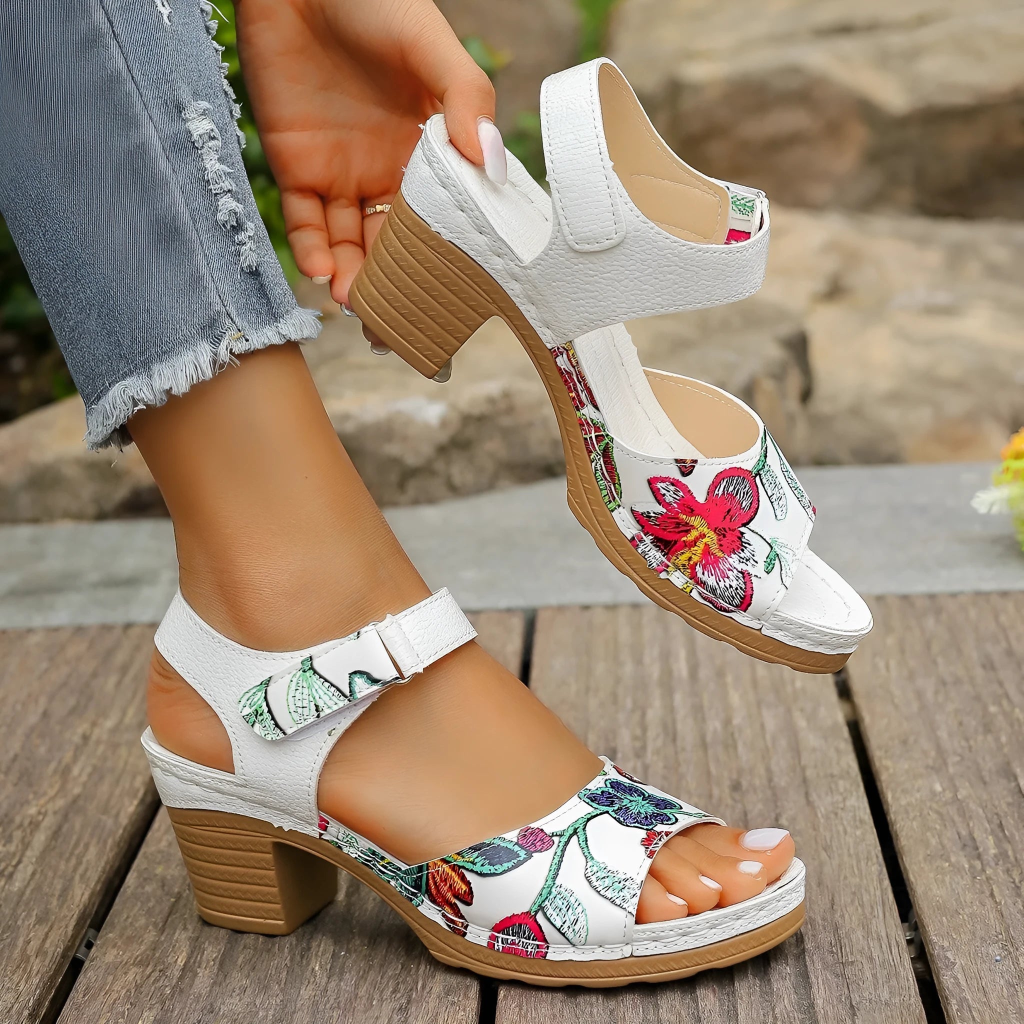 White women's high heel sandals with a Velcro strap buckle and rubber sole.