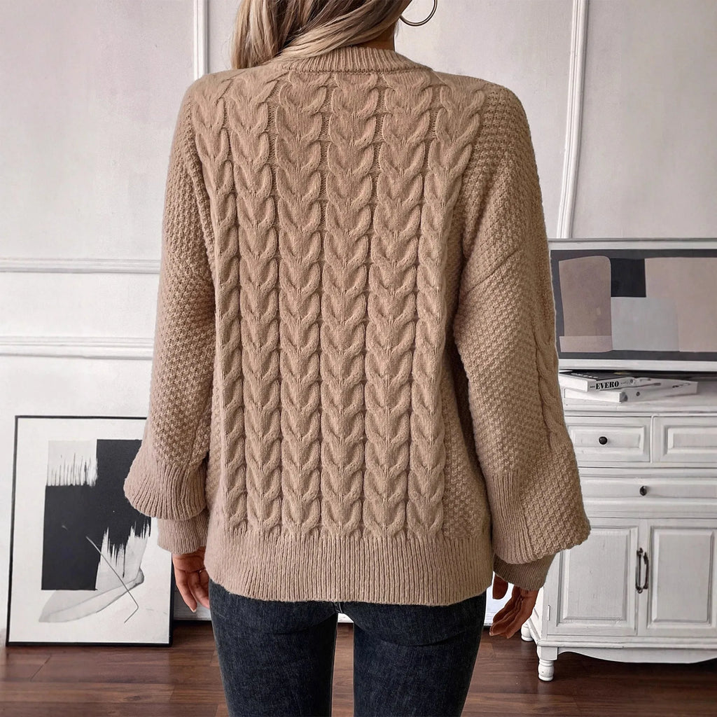 Women's beige loose round neck casual polyester sweater on a hanger.