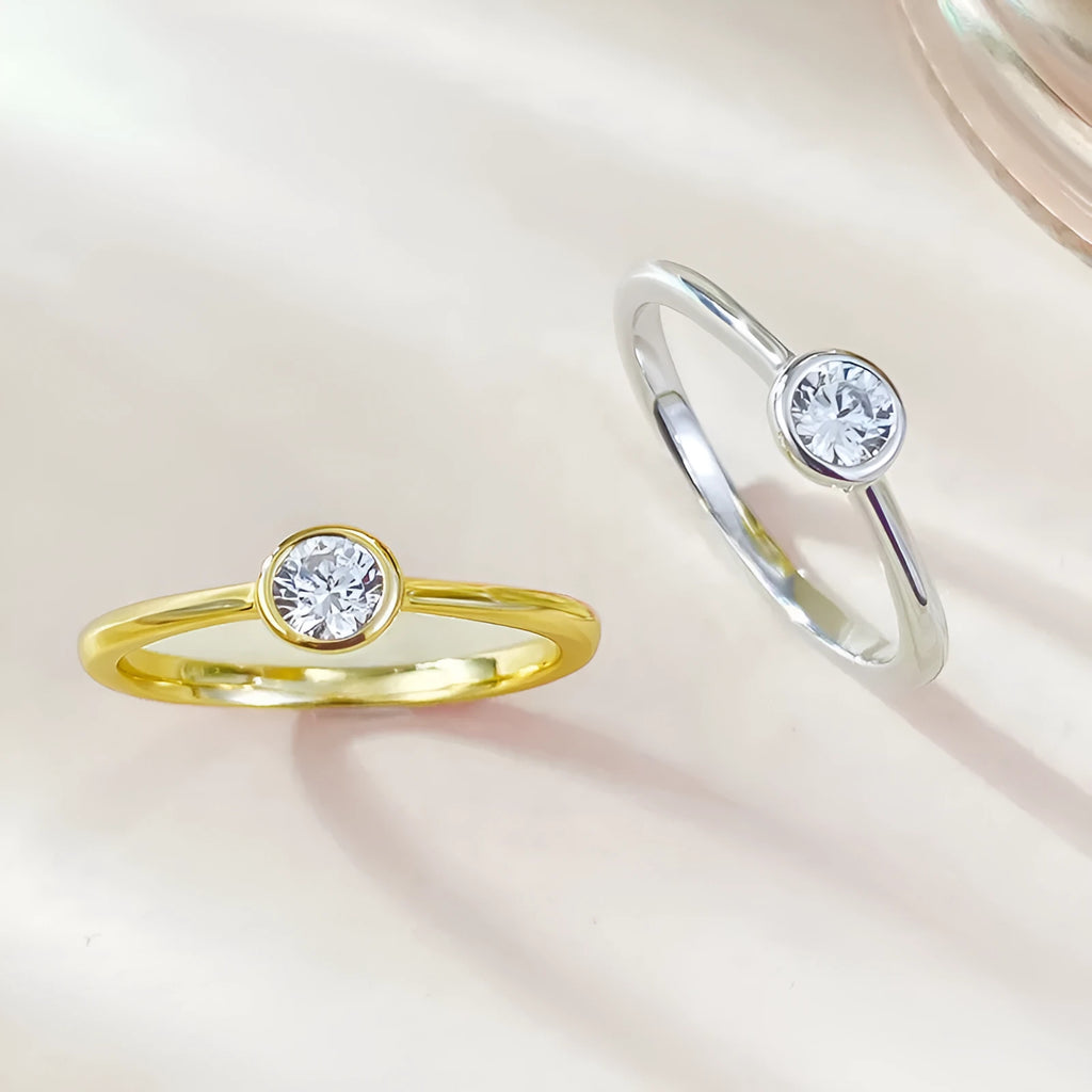 Minimalist crown-shaped silver ring with line detailing, shown in electroplated gold and platinum finishes