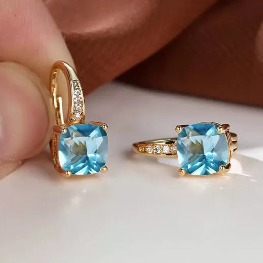Geometric square copper ear clip earrings with moissanite inlays in a gold electroplated finish.