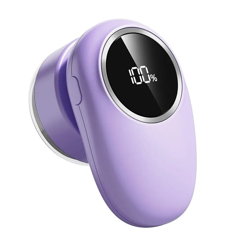 Purple and beige electric fur ball trimmer with digital display and multiple cutter head options on a table.