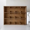 Solid wood square cup storage rack with multiple grid compartments in a birch wood meridian colour.