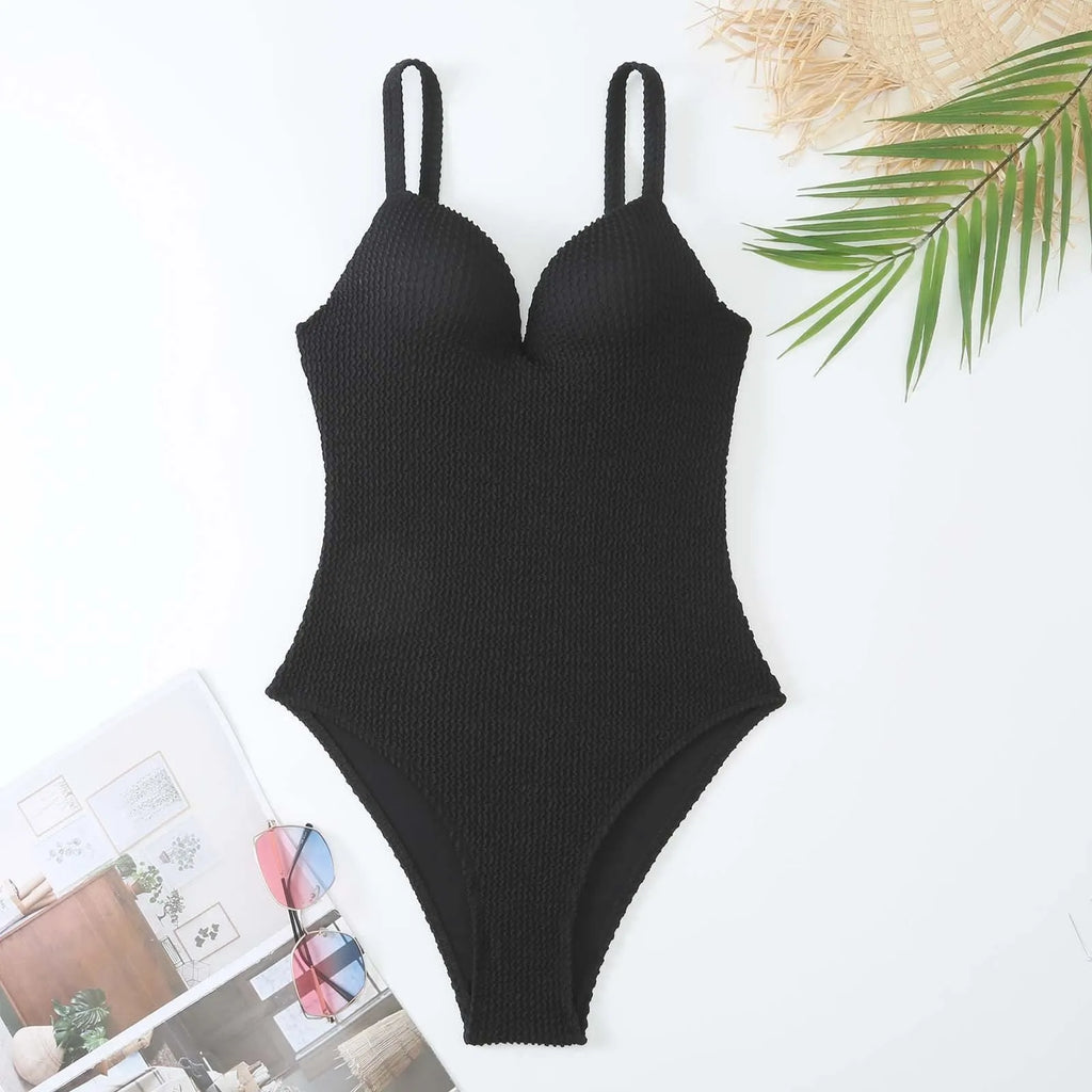 Women's black sunk-stripe one-piece swimsuit made from polyester fabric, sleeveless design.