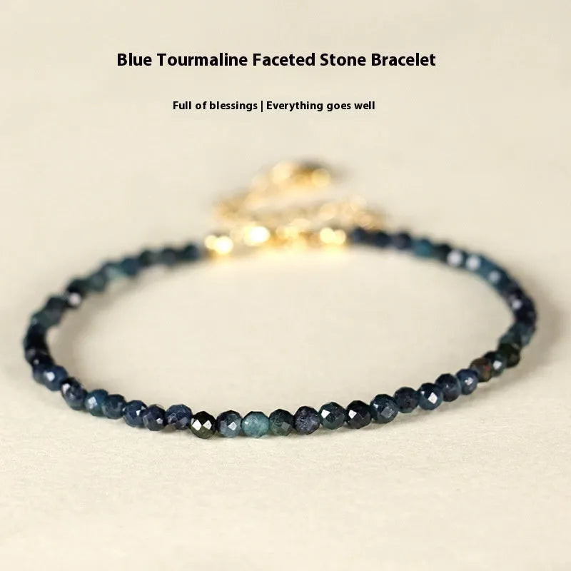 Blue tourmaline bracelet with 3mm beads and spacer bead design on wrist