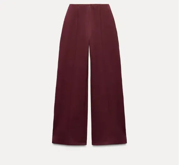 Women's apricot colour polar fleece lounge suit featuring a long sleeve pleated top and wide-leg trousers.