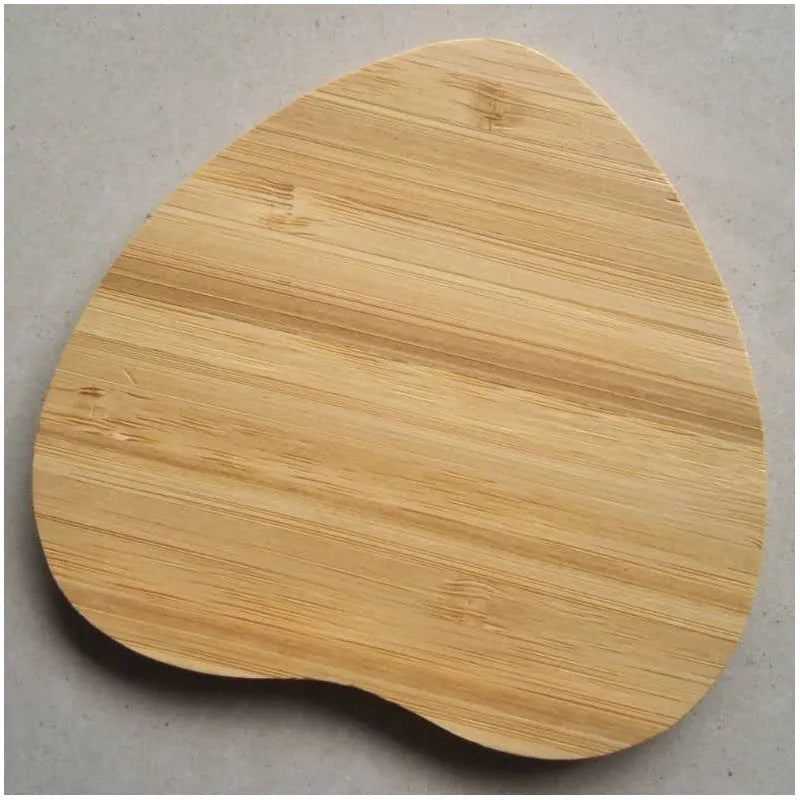 Square brown heart-shaped wooden bamboo 5W wireless charging pad on a table.