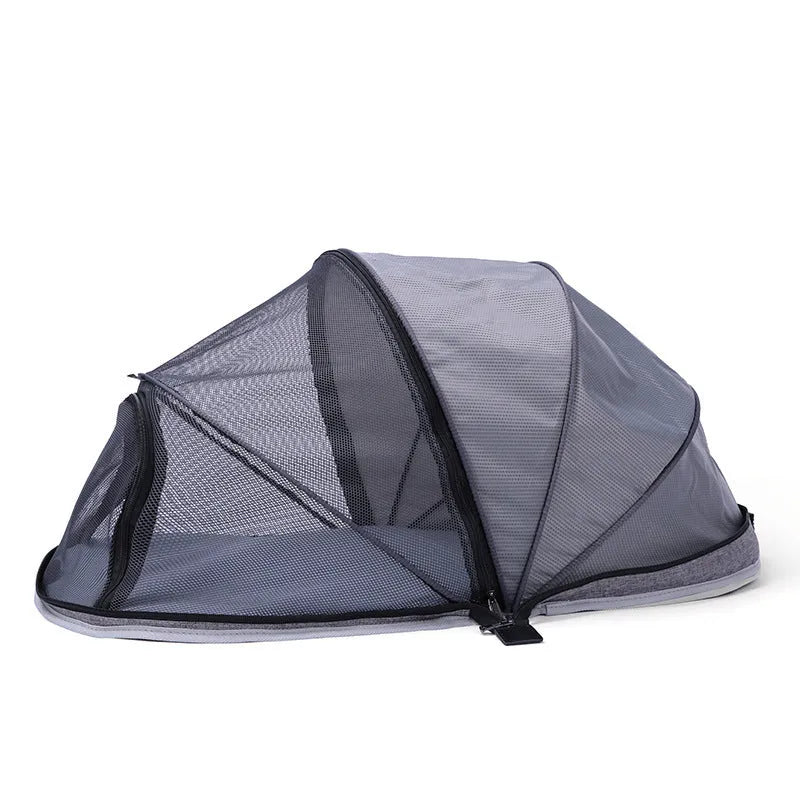 Black half mesh cat folding tent folded for storage with mesh ventilation panels visible