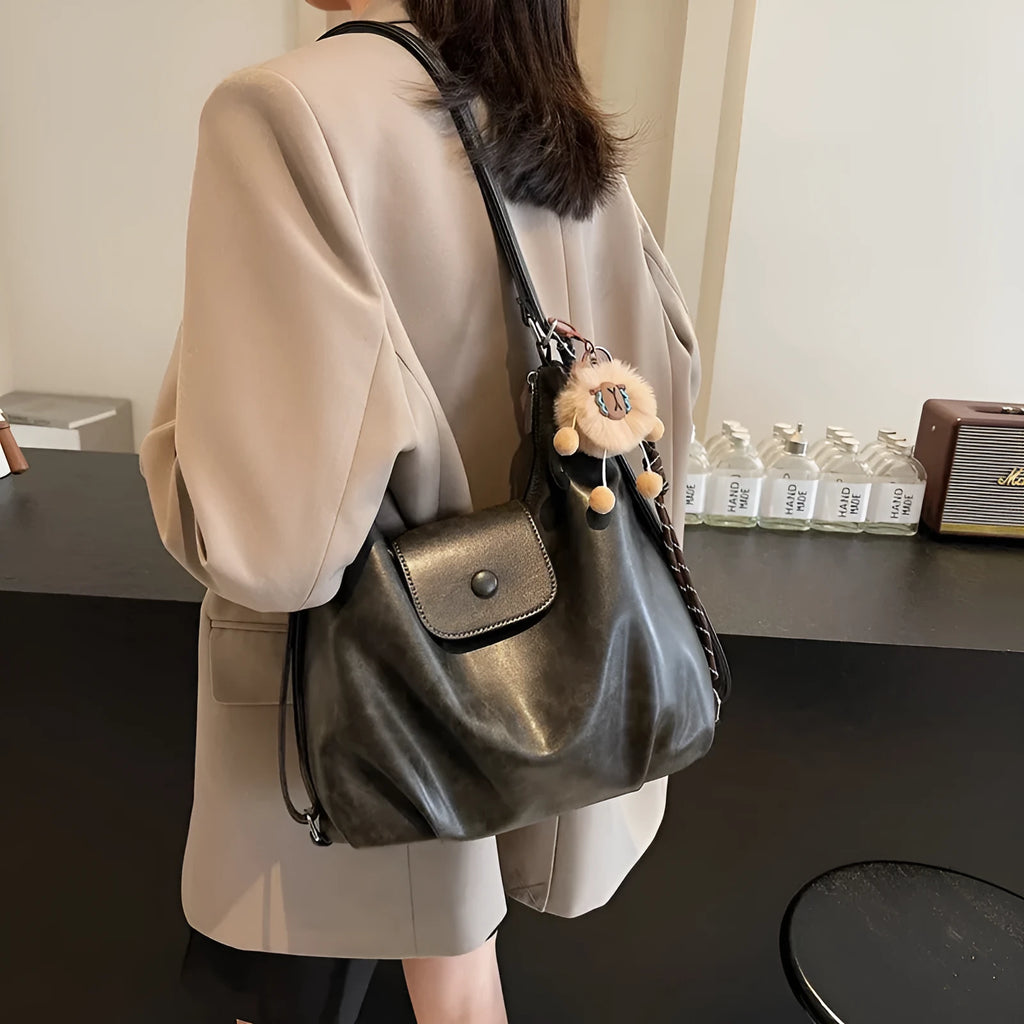 Women's textured PU leather shoulder bag with single strap and mobile phone compartment in black colour