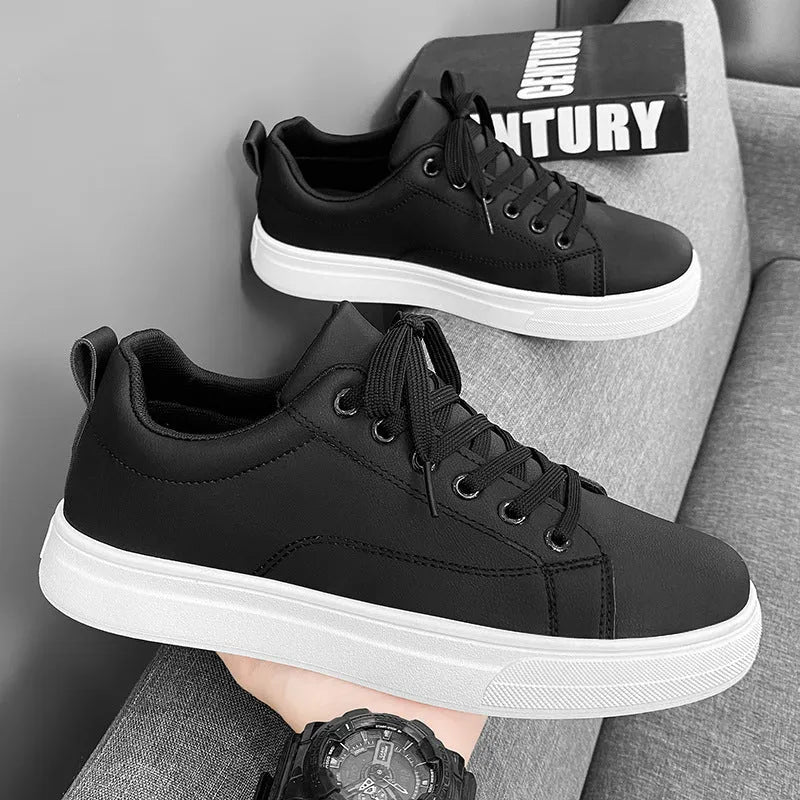 Men's white and black Korean-style low-top casual sneakers with round toe and flat heel.