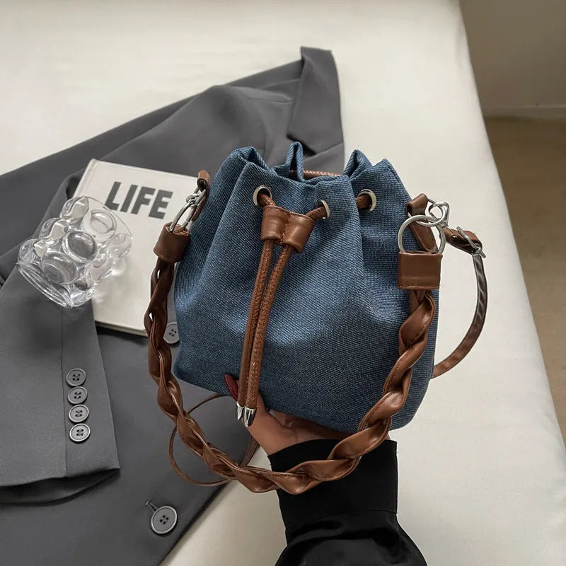 Blue one-shoulder cross body bucket bag with synthetic leather lining and sandwich pocket design