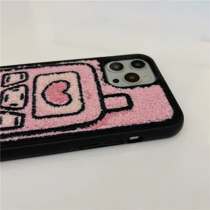 Pink TPU iPhone case with a towel-embroidered pattern, shown fitting an iPhone model.