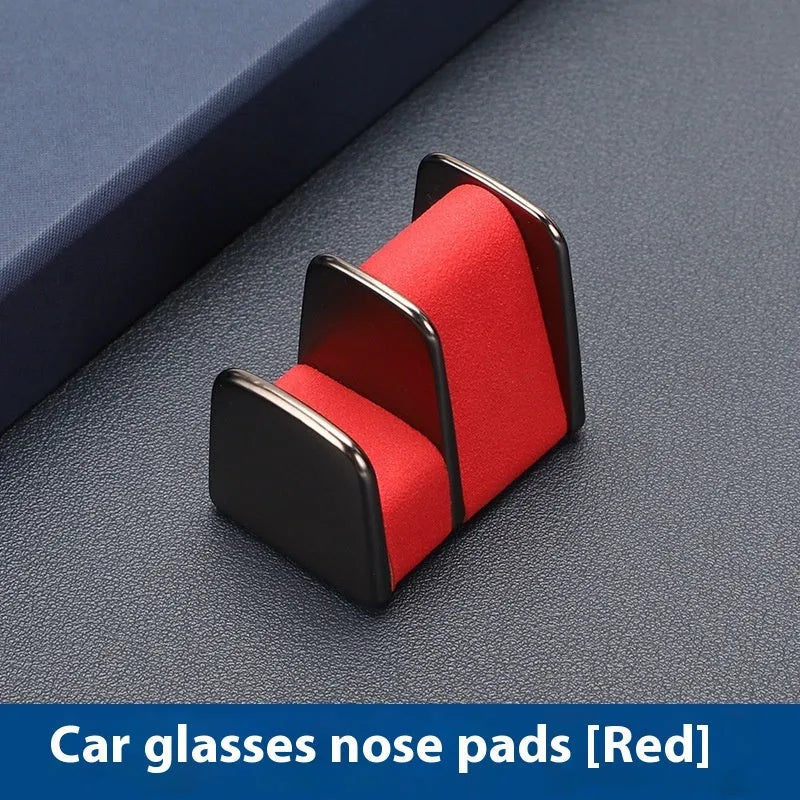 Green zinc alloy and leather glasses clip holder mounted on a car dashboard.