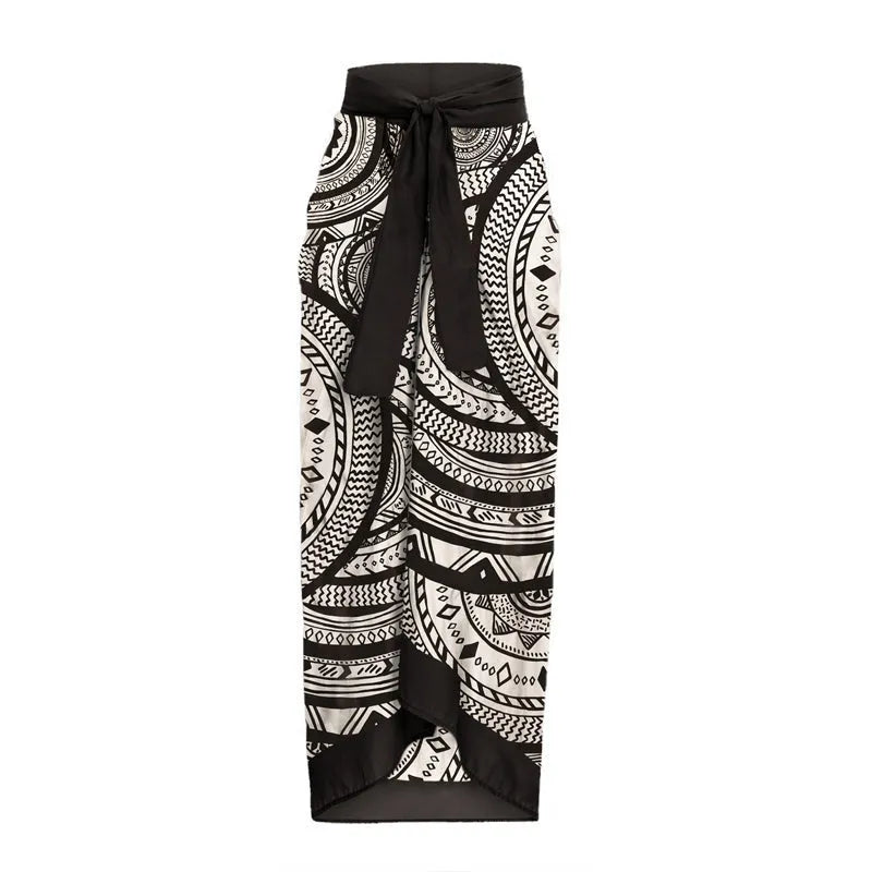 Women's vintage print one-piece swimsuit with deep V-neck and ruffles, shown with matching wrap skirt.