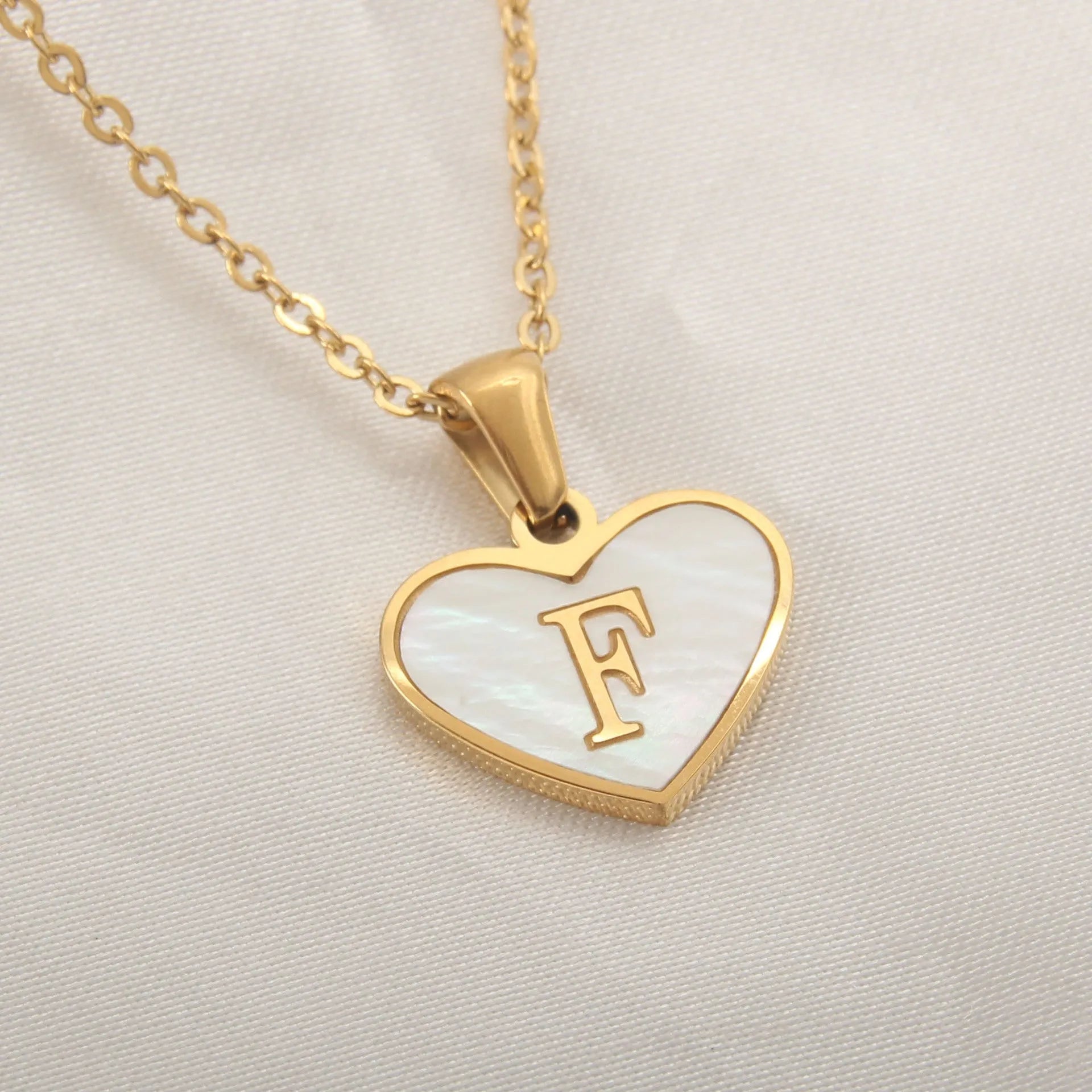 Gold plated heart-shaped personalised necklace with white shell charm on an adjustable chain.