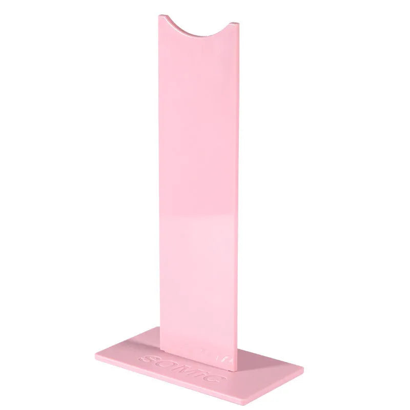 Pink and black detachable gaming headset bracket with silicone non-slip base on a desk
